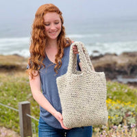 crochet beach bag with ocean background